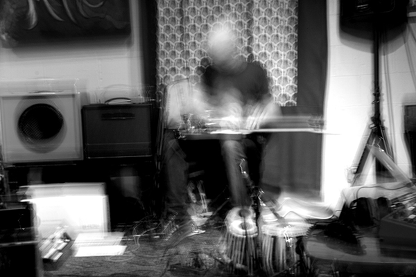 Christopher Burns playing guitar, photographed
    in multiple exposures by Paul Mitchell